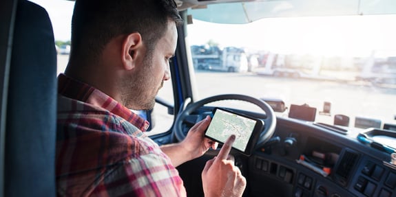 Man in truck in plaid shirt using GPS